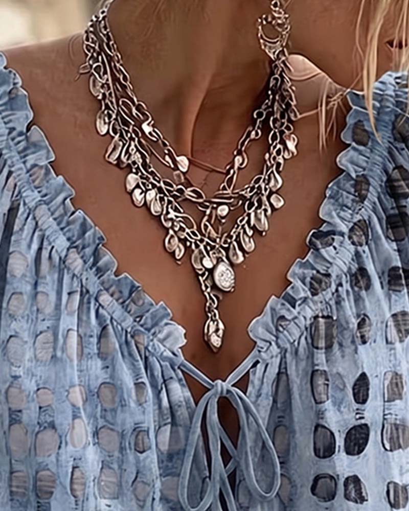 Lena | Blouse met stippenpatroon en vetersluiting