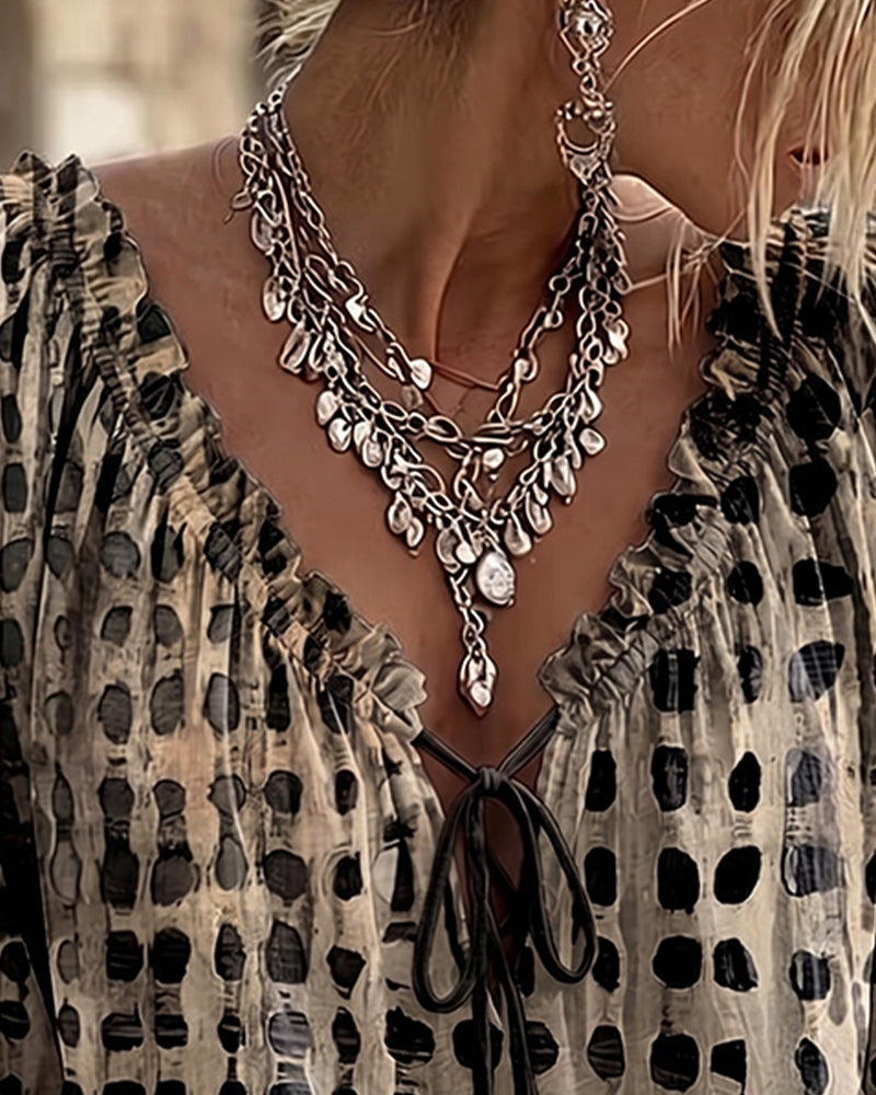 Lena | Blouse met stippenpatroon en vetersluiting